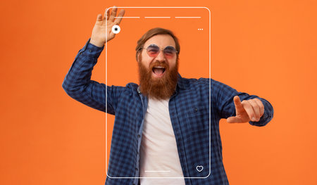 Man Enjoying a Lively Moment With a Phone Frame and Vibrant Background While Dancingの写真素材