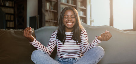 Young Woman Practices Mindfulness at Home, Enjoying a Moment of Peace in Natural Lightの写真素材