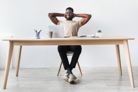Smiling Company Employee Takes a Relaxing Break at Desk During Online Job Hoursの写真素材