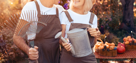 Couple Enjoying Gardening Together During a Sunny Afternoon in Their Backyardの写真素材