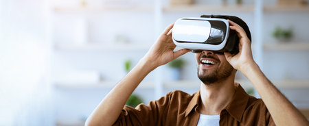 Excited Young Man Experiences Virtual Reality in Bright Indoor Space With Modern Decor