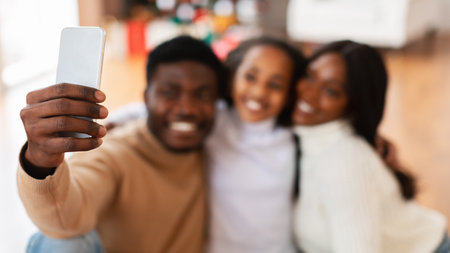 Happy Black Family Enjoys Quality Time Together While Taking a Selfieの写真素材