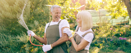 Couple Enjoys Gardening Together in a Sunny Backyard During Springの写真素材
