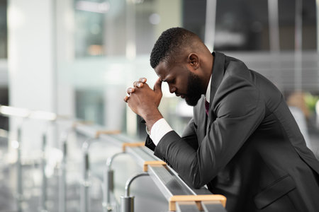Black businessman feeling down after business meetingの写真素材