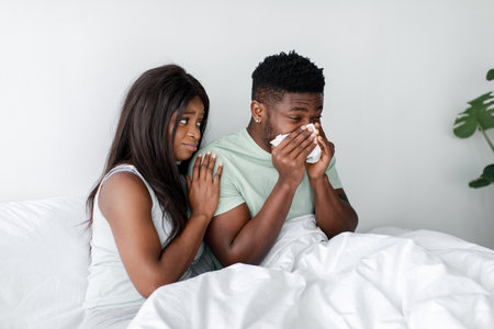 Emotional Support During a Challenging Moment in a Cozy Bedroom Settingの写真素材