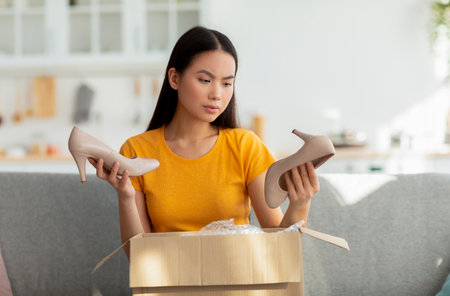Client Discovers Incorrect Delivery of High Heels After Unboxing Experienceの写真素材