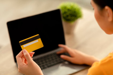 Online Shopping Experience With Credit Card Using Laptop for Purchases at Homeの写真素材