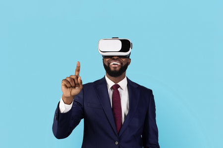 Black Businessman Using VR Glasses And Touching Air With Fingerの写真素材