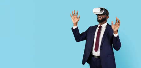 Excited Black Businessman Wearing VR Glasses And Suit Standing On Blue Backgroundの写真素材