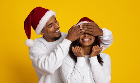 Happy Couple Celebrating Christmas With Playful Surprise in Festive Hatsの写真素材