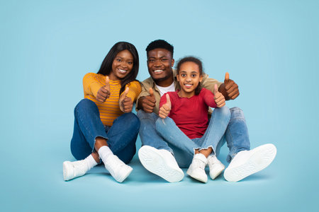 Family Enjoying Quality Time Together With Thumbs up on Blue Background