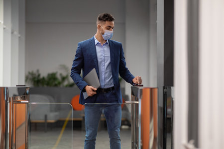 Young Muslim Man Uses Electronic Gate Card While Entering Office Building