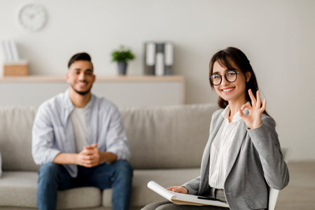 Effective Therapy Session With Psychologist and Millennial Man in Modern Office Settingの写真素材