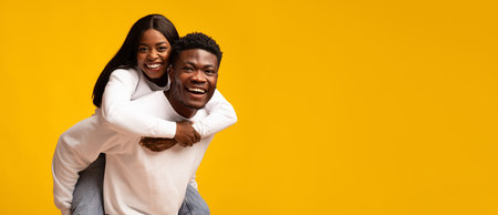 Couple Sharing Joy and Laughter Against a Bright Yellow Backgroundの写真素材