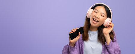 Enjoying Music While Dancing With Headphones in a Relaxed Indoor Settingの写真素材