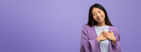 Smiling Woman Expressing Joy Against a Purple Background in a Casual Settingの写真素材