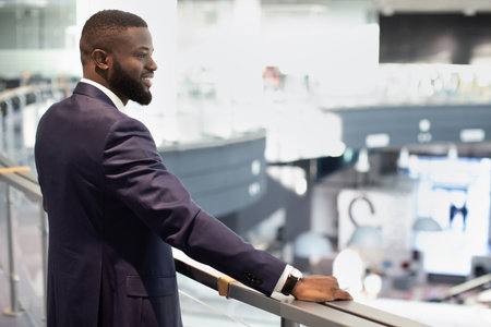 Cheerful african american young businessman looking at his office