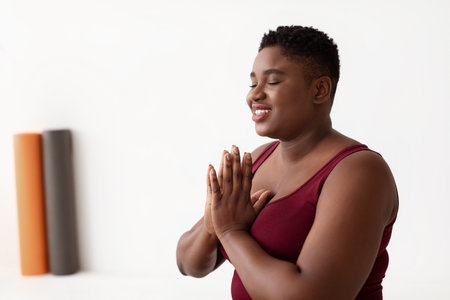 Relaxed Young Woman Meditates in Yoga Studio for a Healthy Lifestyleの写真素材
