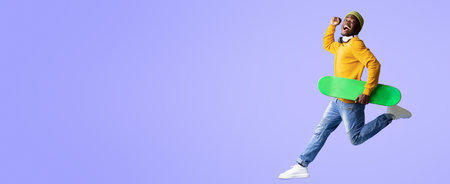 Joyful Young Man Runs With Skateboard Against a Vibrant Purple Backgroundの写真素材