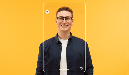 Man Poses in Front of Bright Yellow Background With a Smile and Modern Glasses for a Fun Collageの写真素材