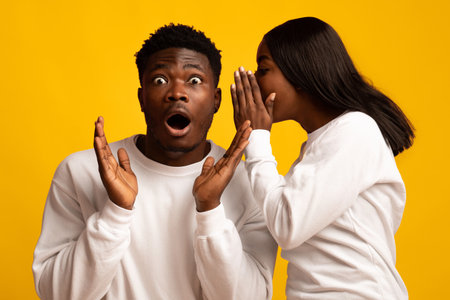 Surprise Moment Between Friends Captured in a Cheerful Yellow Settingの写真素材