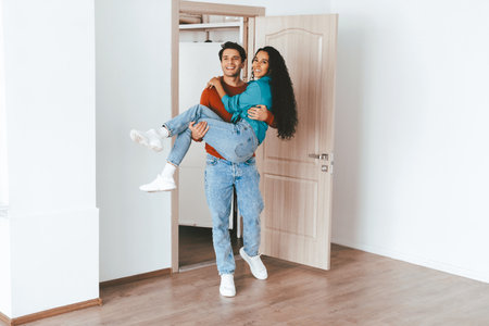 Couple Celebrating Their New Home in an Empty Room During Daylightの写真素材