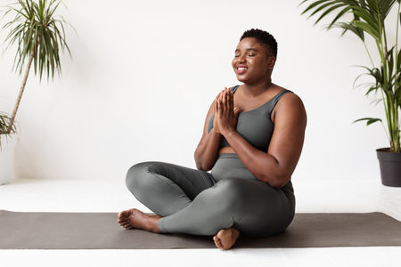 Relaxed Young Woman Meditating at Home for Wellness and Mindfulness Practice