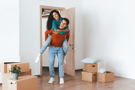 Couple Moving Into New Apartment With Joy and Excitement as Boxes Surround Themの写真素材