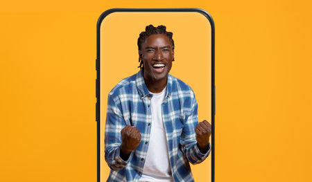 Happy Person Celebrating Joy in a Vibrant Yellow Setting With a Smartphone Frameの写真素材