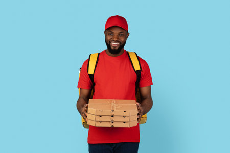 Portrait Of Black Delivery Guy In Uniform Holding Stack Of Pizza Boxesの写真素材