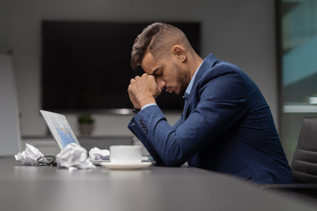 Upset Middle Eastern Manager Seeks Creative Solutions in Business Meeting Environmentの写真素材