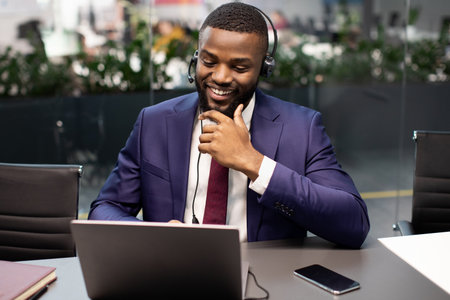 Handsome black manager having video interview with employee