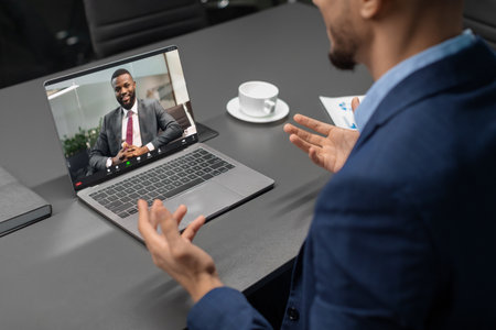 Businessman Engages in Video Conference With CEO Discussing Modern Solutions and Strategiesの写真素材