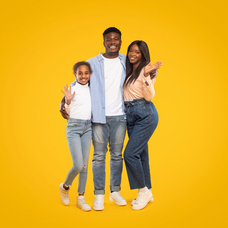 Family Poses Together in a Cheerful Setting With a Bright Yellow Backgroundの写真素材