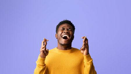 Man Smiling Widely With Crossed Fingers in a Cheerful Setting