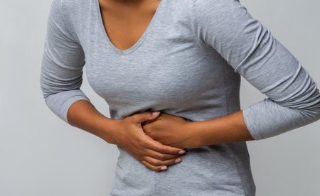 African American woman suffering from gastritis, touching her tummyの写真素材
