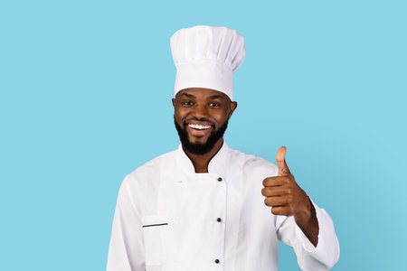 Great Recipe. Portrait Of Smiling Black Chef In Uniform Showing Thumb Upの写真素材