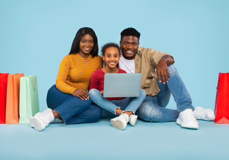 Family Enjoys Online Shopping Together in Colorful Surroundingsの写真素材