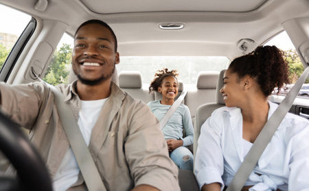 Joyful Family Driving New Car Having Ride In Cityの写真素材