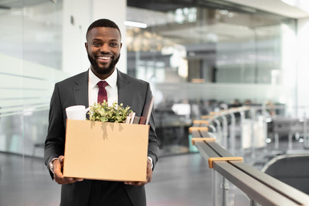Happy african american young man employee with working stuffの写真素材
