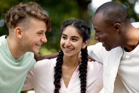 Friends Enjoying a Sunny Day Outdoors, Sharing Laughter and Smiles in a Natural Settingの写真素材