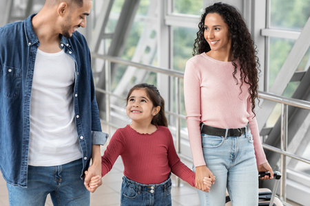 Family Enjoying Quality Time Together While Walking in a Modern Airport Terminalの写真素材