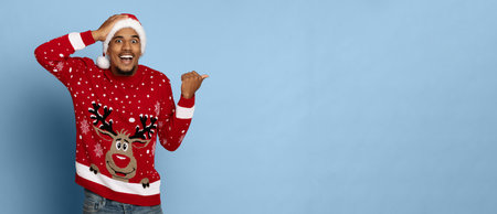 Surprised Man in Festive Sweater Celebrating During the Holiday Seasonの写真素材