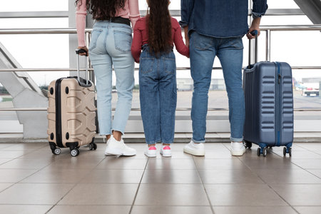 Family Explores Airport Terminal With Luggage Ready for Their Next Adventureの写真素材