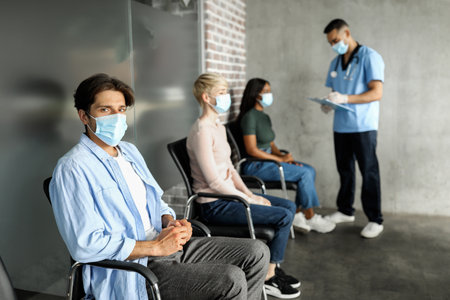 Multiethnic patients waiting for vaccination against coronavirus at clinicの写真素材