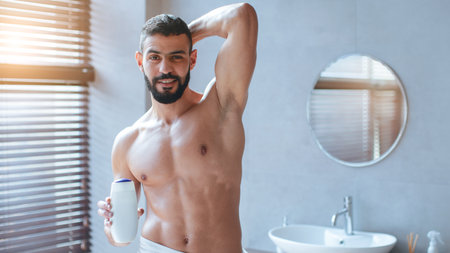 Man Applying Grooming Product in Modern Bathroom During Daytimeの写真素材