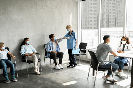 Female doc greeting male patient with elbow bumpの写真素材