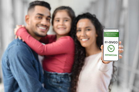 Family Proudly Shows COVID-19 Vaccination Certificate at a Modern Location With Bright Lightingの写真素材