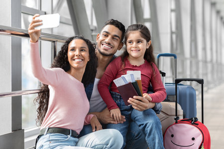 Family Enjoys Quality Time at the Airport While Preparing for Their Upcoming Adventure Togetherの写真素材