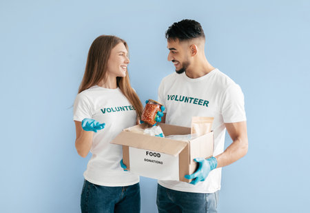 Young Volunteers Share Joy While Organizing Food Donations for Those in Needの写真素材